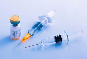 closeup-two-syringes-beside-vial-vaccine-flu-covid-19-measles-other-diseases-1200x818